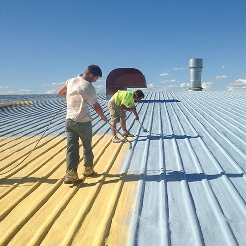 Contractors Spray Coating on Metal Roof.